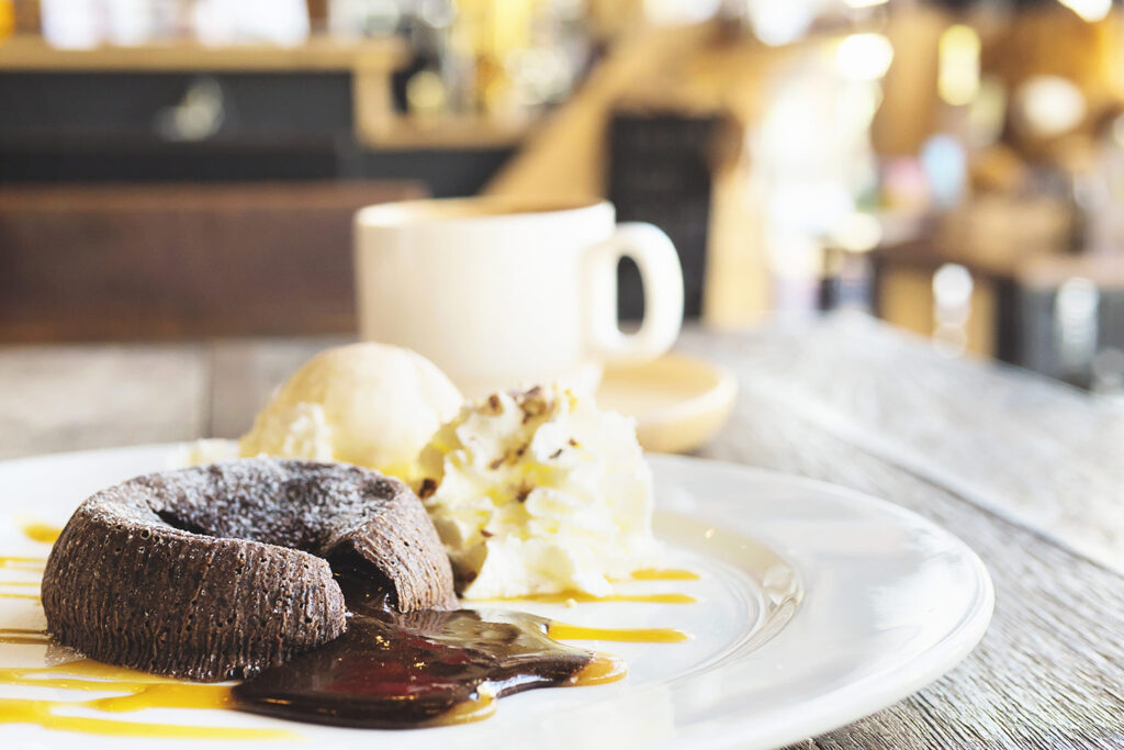 chocolate-lava-cake-white-plate-with-coffee-cup-coffee-shop