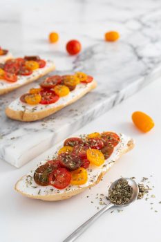 high-angle-sandwiches-with-cream-cheese-tomatoes-marble-counter