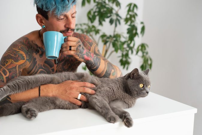 man-being-affectionate-with-cat-medium-shot